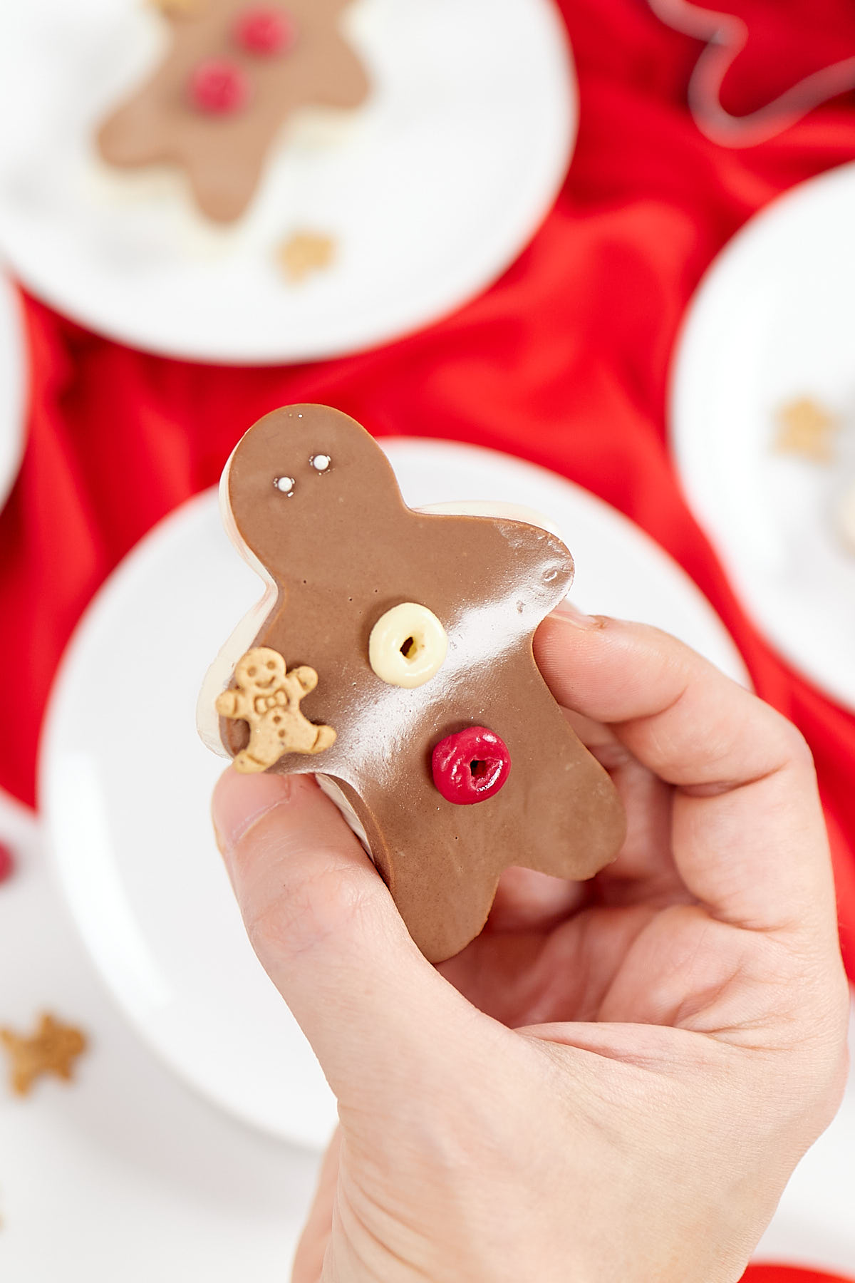 Gingerbread man jello jiggler with gingerbread sprinkle on hand.