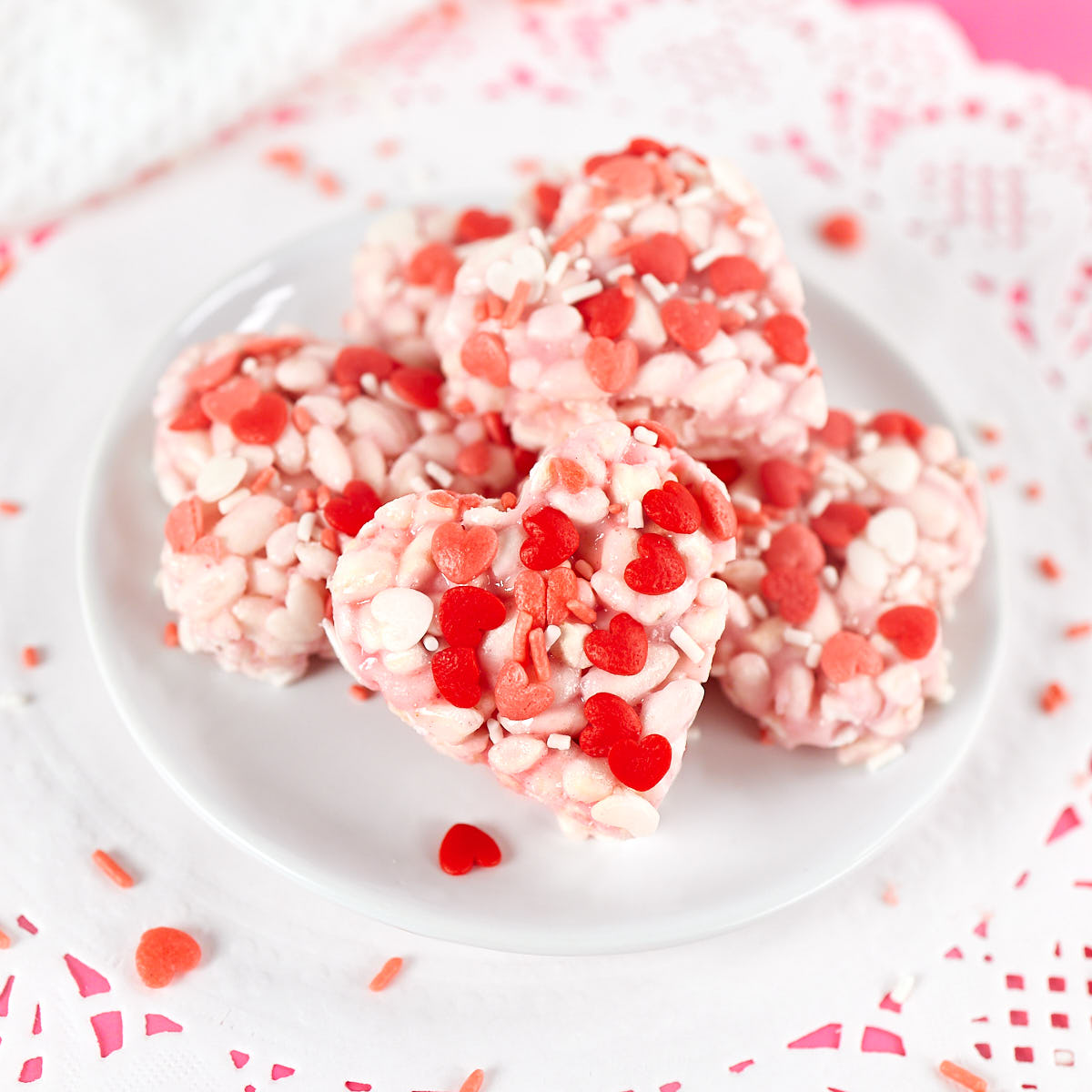 Homemade Valentine's day rice krispies treats with red and pink heart sprinkles.